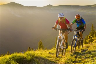 Caucasian couple mountain biking