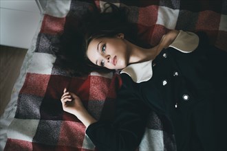 Portrait of Caucasian woman laying on blanket