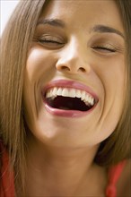 Mixed race woman smiling with eyes closed