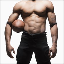 Midsection of bare chested football player