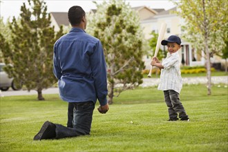 Father teaching son to play baseball
