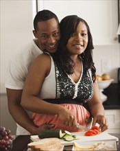 Couple cooking together in kitchen