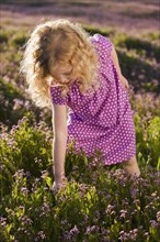 Caucasian girl picking flowers