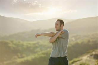 Caucasian man stretching before exercise