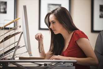 Caucasian woman working at desk in home office