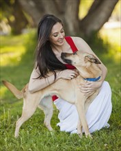 Caucasian woman hugging dog