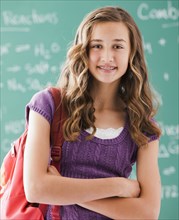 Caucasian teenager standing in classroom