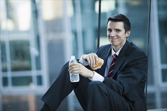 Caucasian businessman eating lunch
