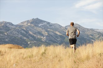 Caucasian man running in remote area