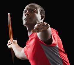 African American man holding track and field javelin