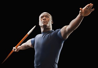 African American man holding track and field javelin