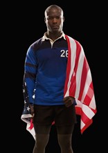 African American rugby player wrapped in American flag