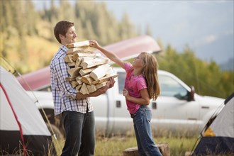 Caucasian father and daughter gathering firewood