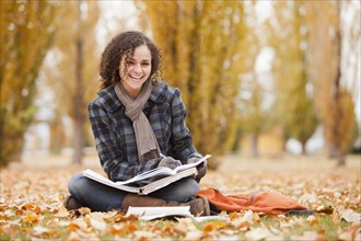 Caucasian woman doing home work in autumn leaves