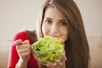 Caucasian woman eating salad
