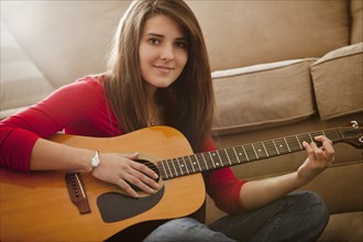 Caucasian woman playing guitar