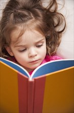 Caucasian girl reading a book