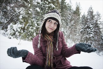 Caucasian woman sitting in the snow