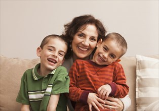 Caucasian grandmother sitting with grandsons