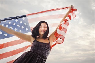 Caucasian woman holding American flag