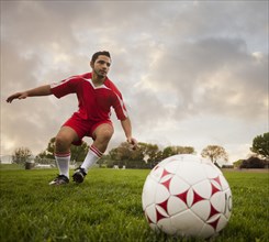 Hispanic soccer player about to kick the ball