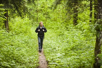 Caucasian man hiking in woods
