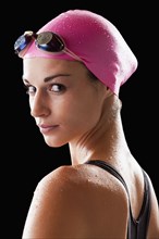 Caucasian swimmer in swim cap and goggles