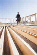 Caucasian man standing with frame on construction site