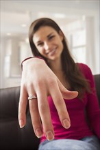 Caucasian woman displaying engagement ring