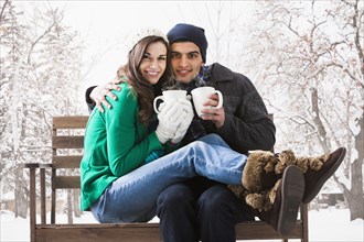 Couple having coffee together in snow