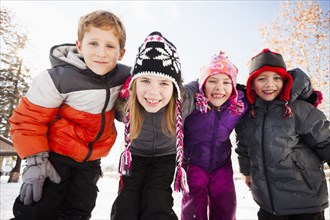 Caucasian children smiling in snow