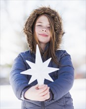 Caucasian girl holding decorative star