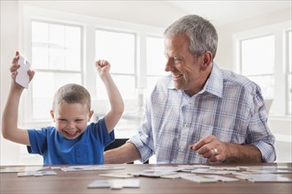Caucasian father and son playing cards