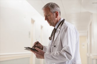 Caucasian doctor using tablet computer