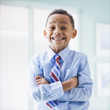 Mixed race boy wearing shirt and tie
