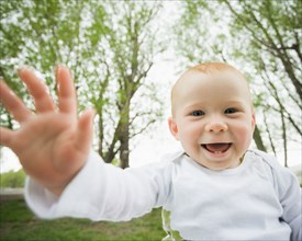 Caucasian baby laughing outdoors