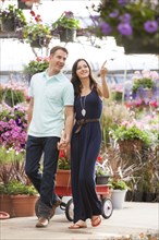 Caucasian couple shopping in plant nursery