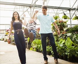 Caucasian family shopping in plant nursery