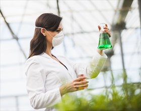 Caucasian scientist working in greenhouse