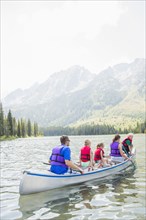 Caucasian family in canoe on lake