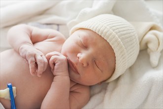 Caucasian newborn baby laying on blanket