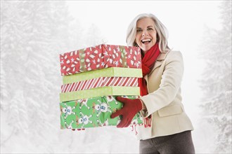 Portrait of enthusiastic Caucasian woman with Christmas gifts