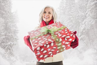 Portrait of smiling Caucasian woman with Christmas gift