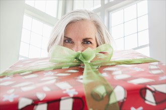 Close up portrait of Caucasian woman with Christmas gift