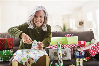 Caucasian woman wrapping Christmas gifts