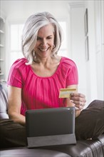 Smiling Caucasian woman shopping online