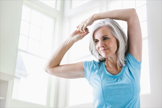 Caucasian woman stretching arms