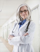 Portrait of confident Caucasian doctor in corridor