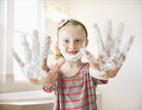 Caucasian girl playing with shaving cream