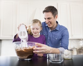 Caucasian father and daughter baking together